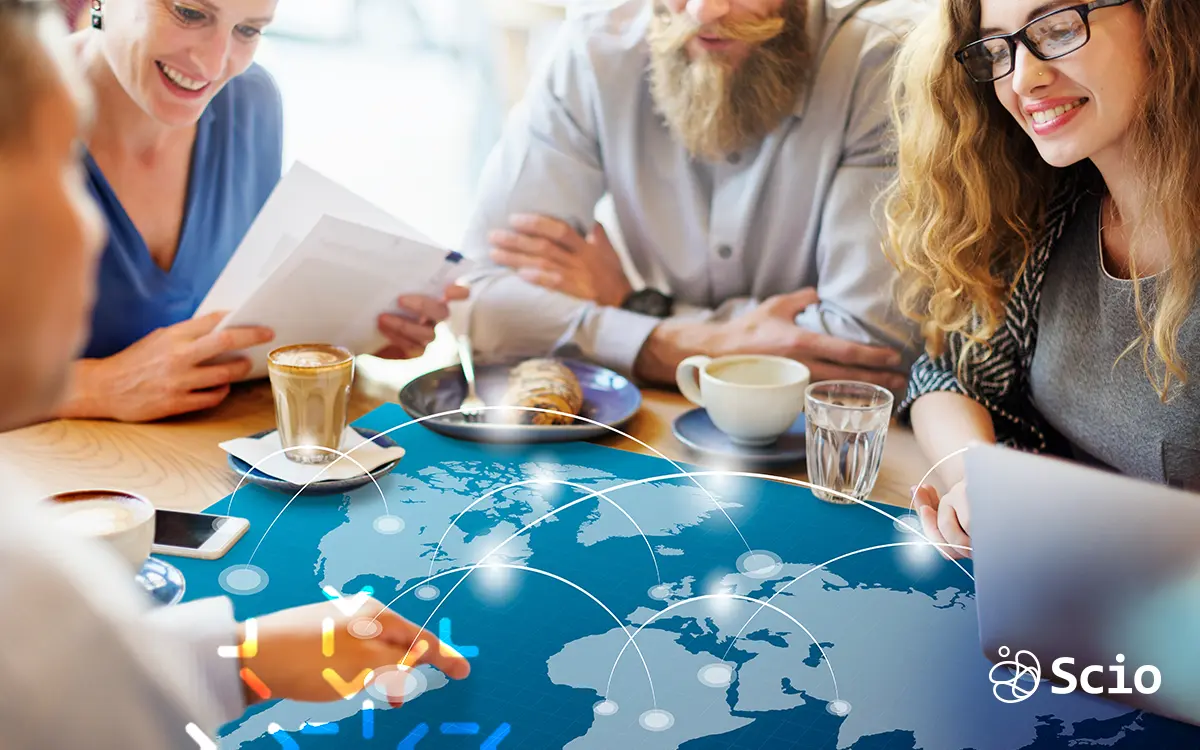 Scio’s Nearshoring Model: Agile, Secure, and Regionally Aligned Software Delivery Scio team collaborating over a digital world map, representing strategic nearshoring opportunities in Mexico and Latin America